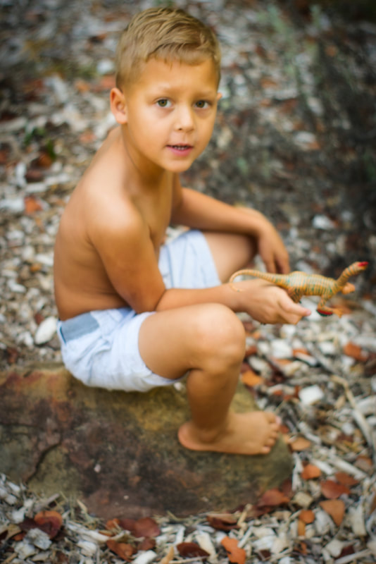 Portrait of a boy sitting on a rock in Libby Park, Ojai California